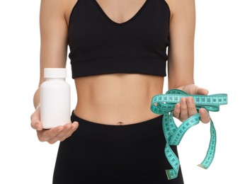 Photo of Woman with bottle of pills and measuring tape on white background, closeup. Weight loss