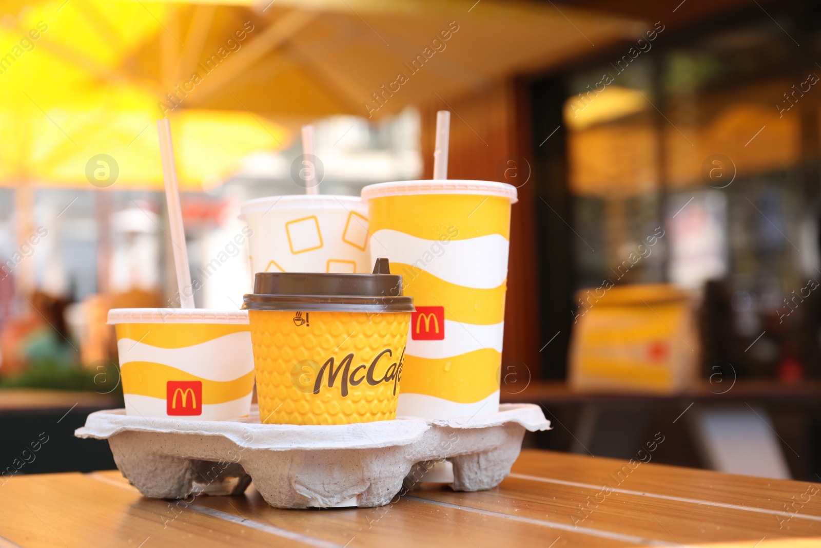 Photo of MYKOLAIV, UKRAINE - AUGUST 11, 2021: Cold and hot McDonald's drinks on table in cafe