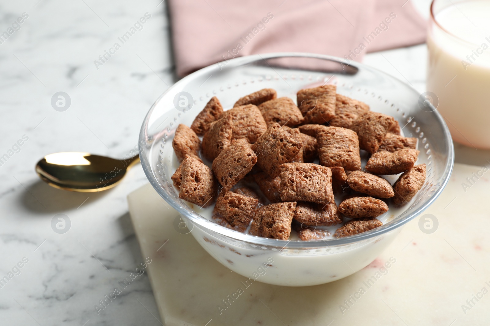 Photo of Tasty corn pads with milk served for breakfast on white marble table, closeup