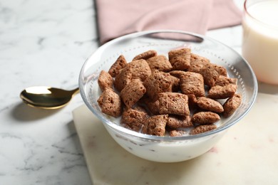 Tasty corn pads with milk served for breakfast on white marble table, closeup