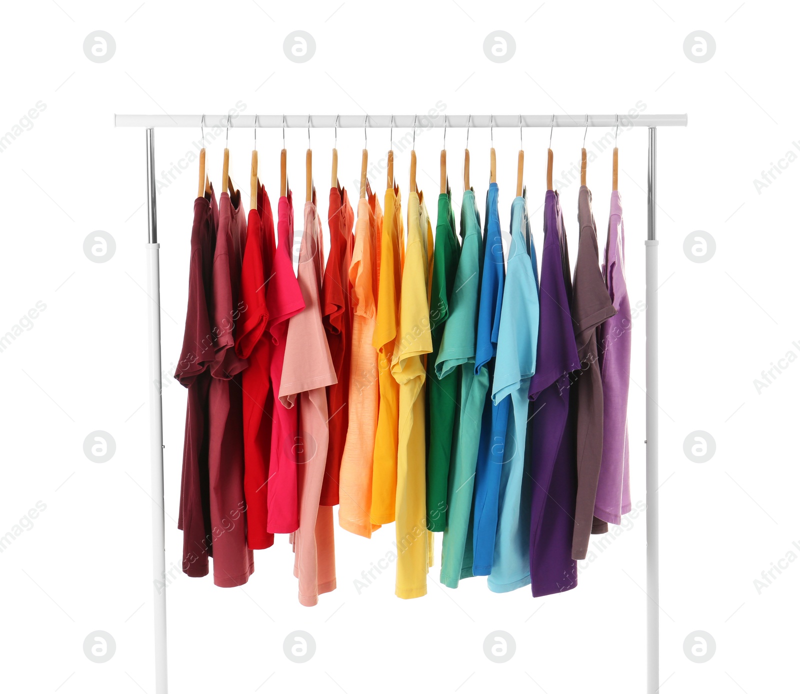 Photo of Many t-shirts hanging in order of rainbow colors on white background