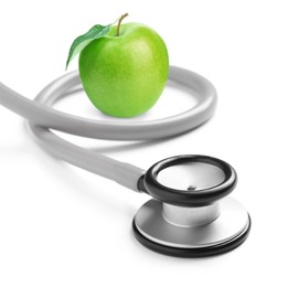 Image of Stethoscope and green apple on white background 