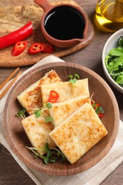 Photo of Delicious turnip cake with microgreens on wooden table, flat lay