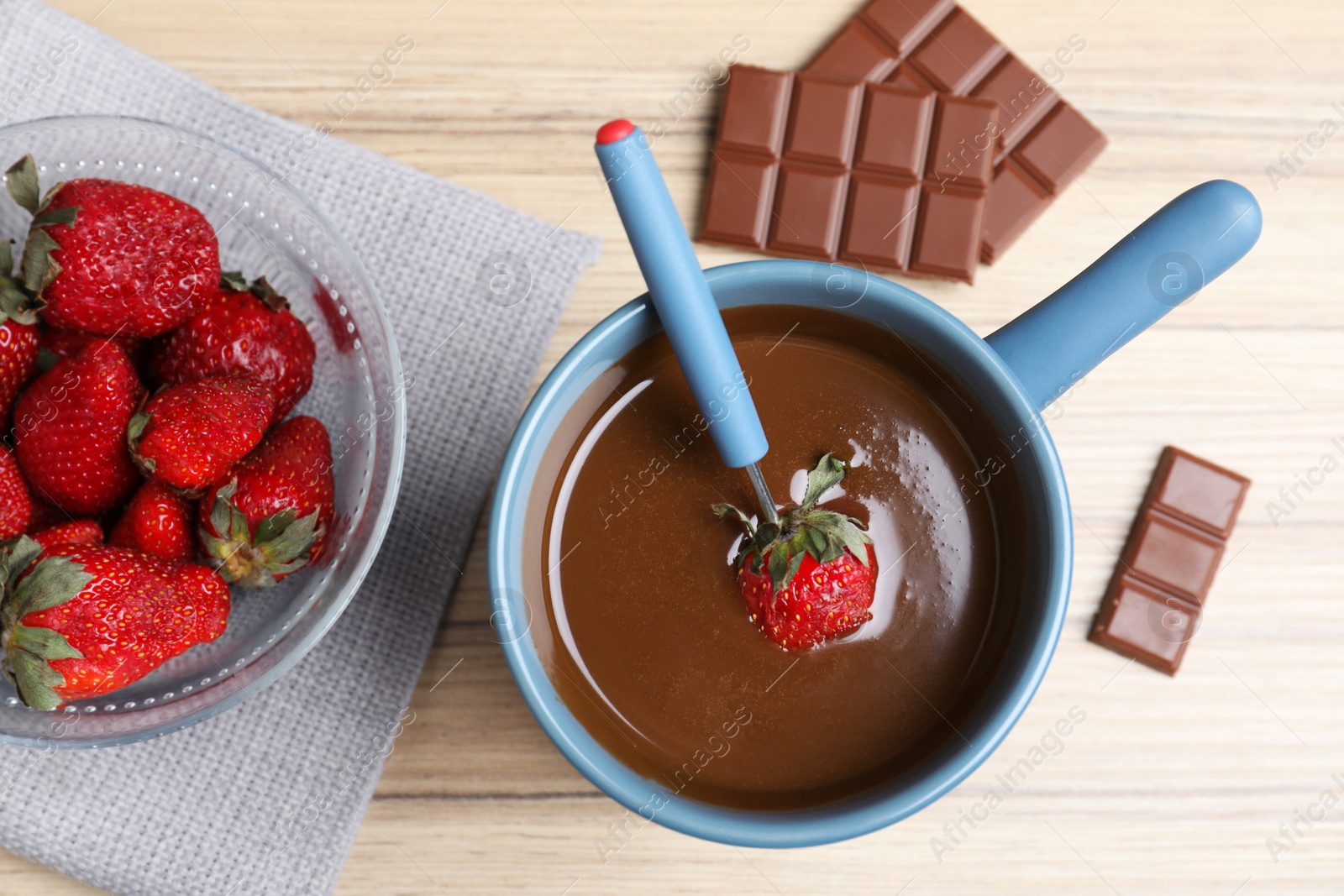 Photo of Flat lay composition with chocolate fondue on wooden background