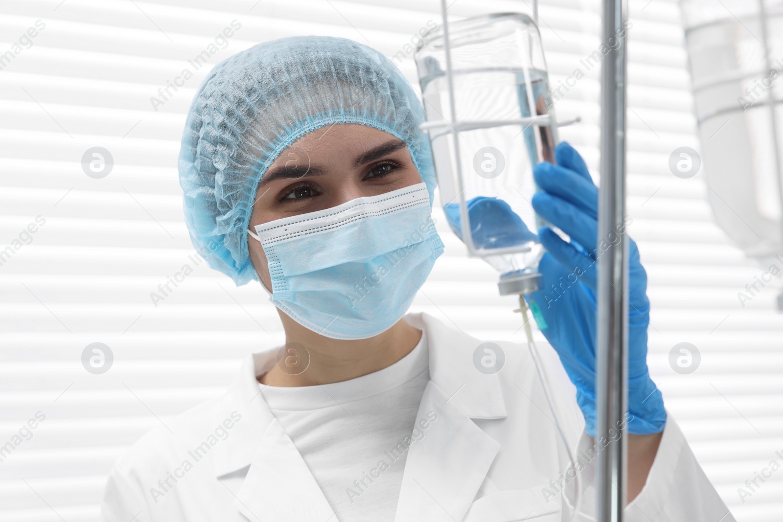 Photo of Nurse setting up IV drip in hospital