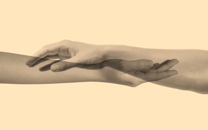 Image of Double exposure of people's hands on beige background, closeup. Sepia effect