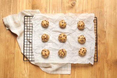 Uncooked chocolate chip cookies on wooden table, top view