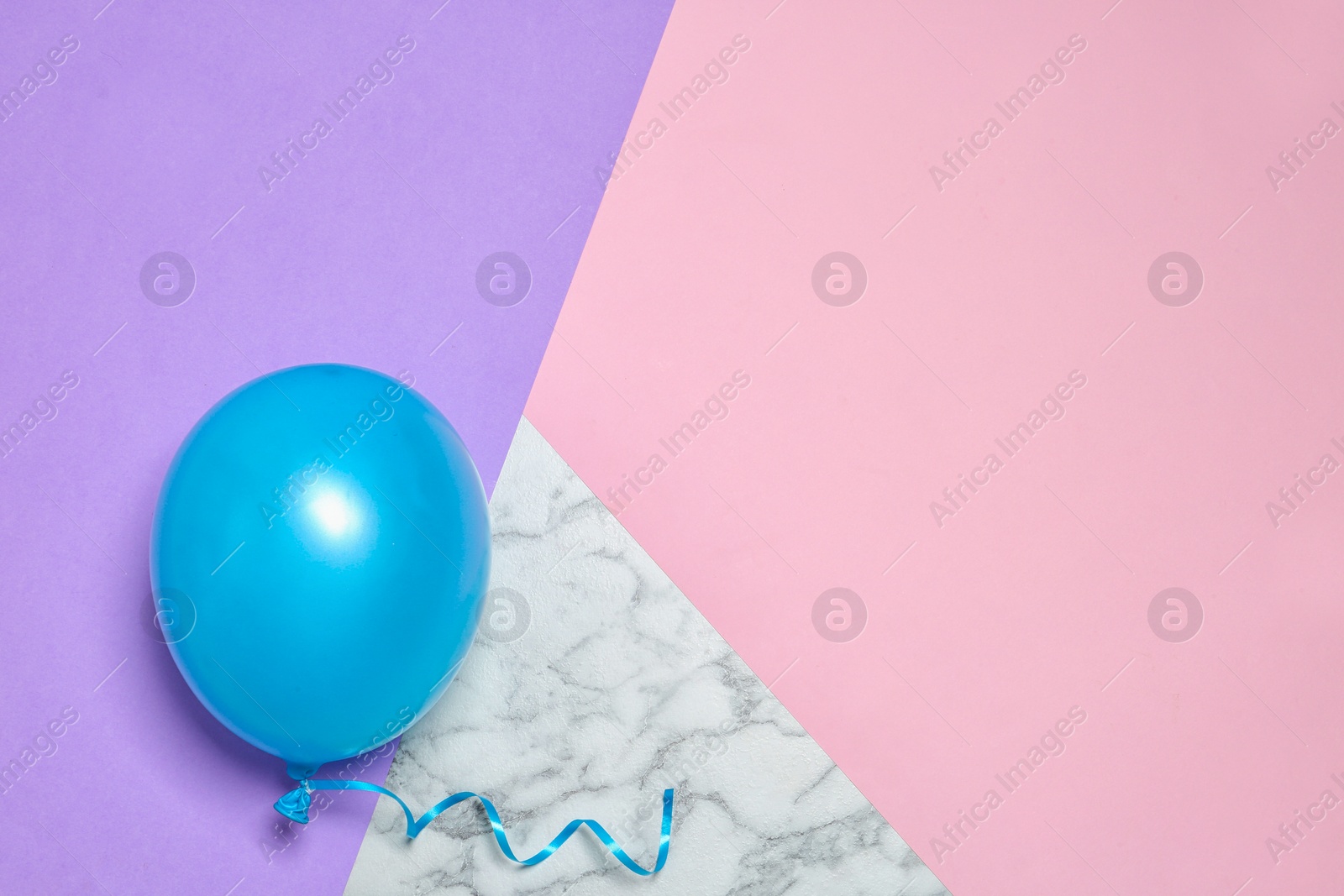 Photo of Bright balloon on colorful background, top view with space for text. Party time