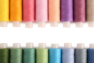 Set of colorful sewing threads on white background, flat lay. Space for text