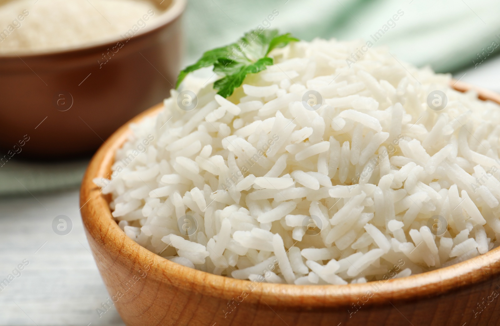 Photo of Bowl of tasty cooked white rice on table, closeup