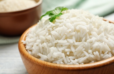 Bowl of tasty cooked white rice on table, closeup