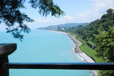 Picturesque view of distant city and beautiful sea on sunny day