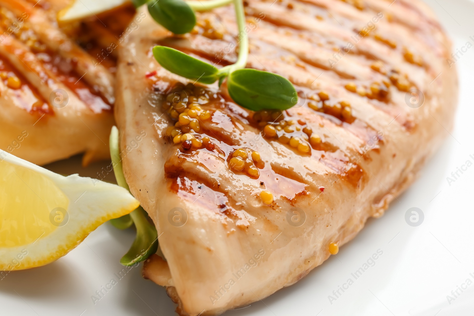 Photo of Tasty grilled chicken fillets with green sprout and mustard on white background, closeup