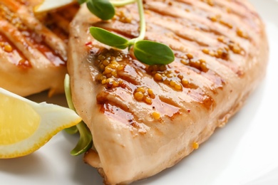 Photo of Tasty grilled chicken fillets with green sprout and mustard on white background, closeup