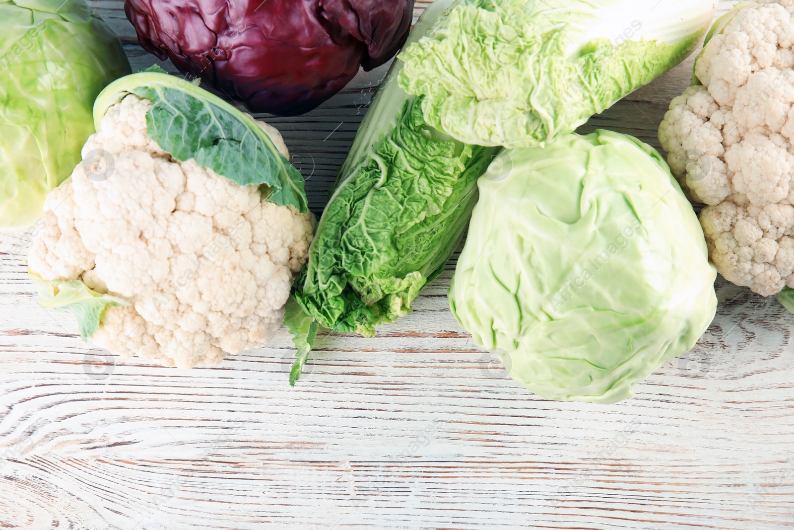 Photo of Flat lay composition with different cabbages on wooden background