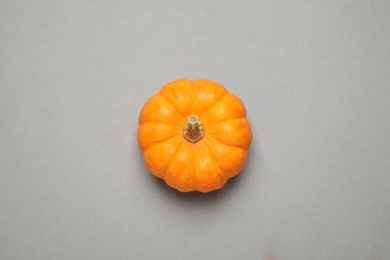 Photo of Fresh ripe pumpkin on grey background, top view