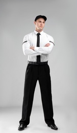 Photo of Male security guard in uniform on color background