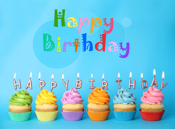 Text Happy Birthday and delicious cupcakes with burning candles on light blue background