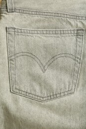 Stylish light grey jeans, closeup of back pocket