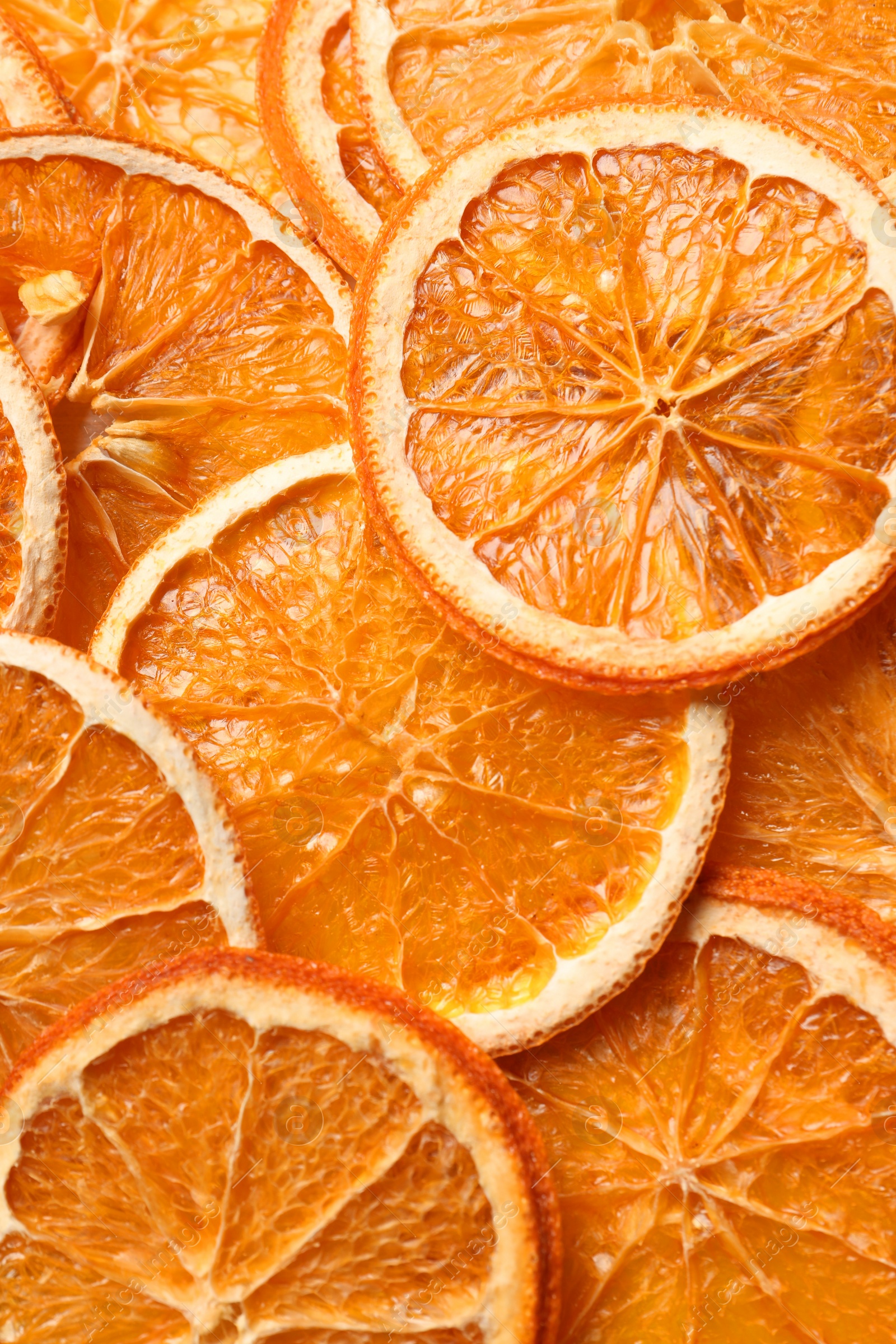 Photo of Heap of dry orange slices as background, top view