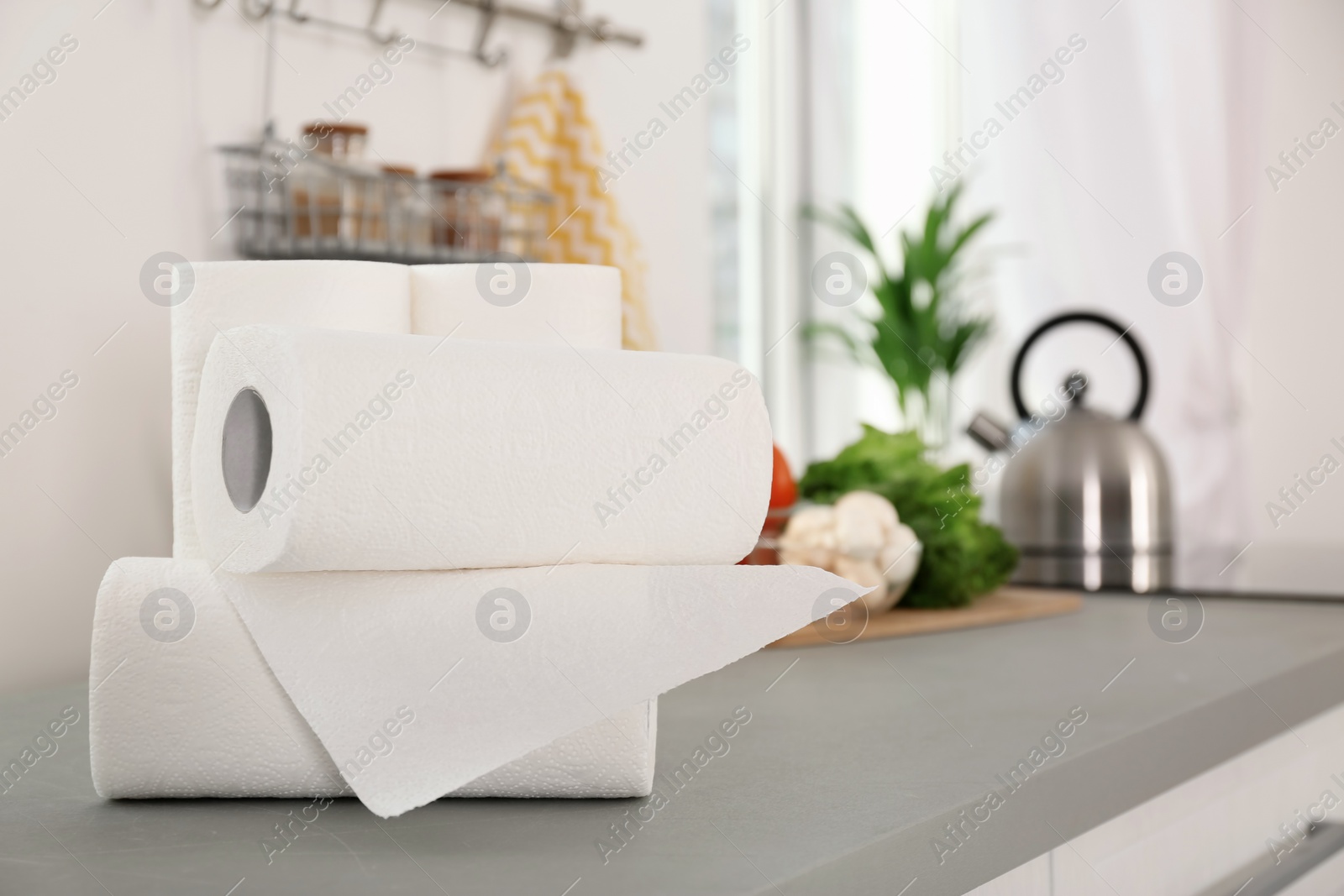 Photo of Rolls of paper towels on table in kitchen