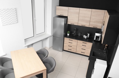Photo of Cozy modern kitchen interior with new furniture and appliances