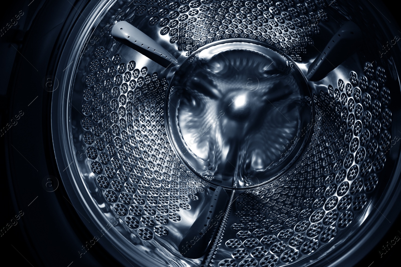 Photo of Empty washing machine drum, closeup. Laundry day