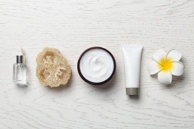 Photo of Flat lay composition with body care products on white wooden background