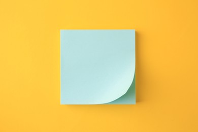Photo of Blank paper note on orange background, top view