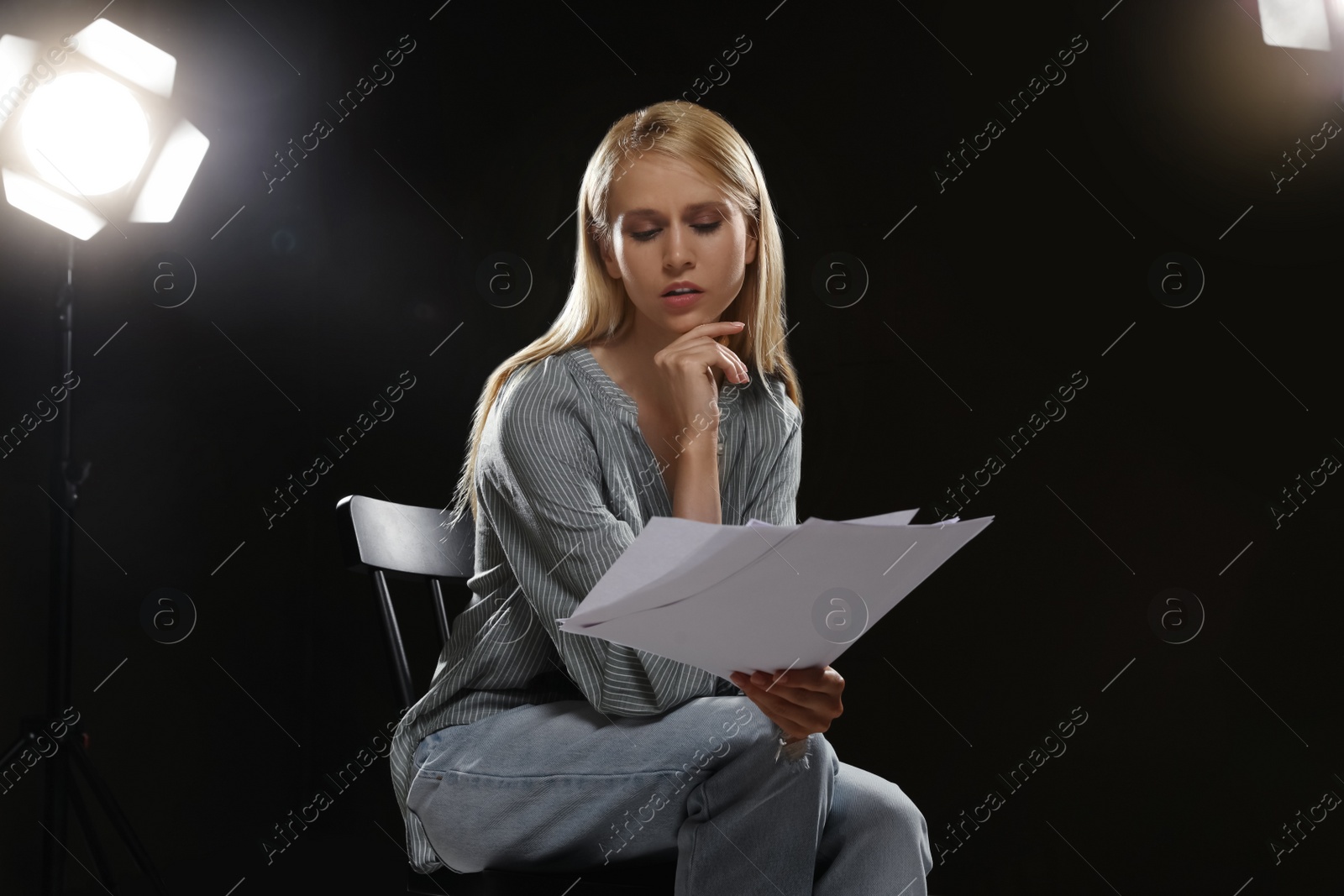 Photo of Professional actress reading her script during rehearsal in theatre