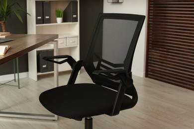 Stylish office chair at workplace in room. Interior design