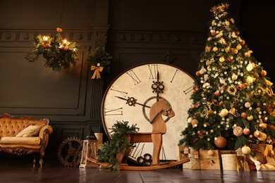 Photo of Stylish room interior with Christmas tree, big vintage clock and festive decor