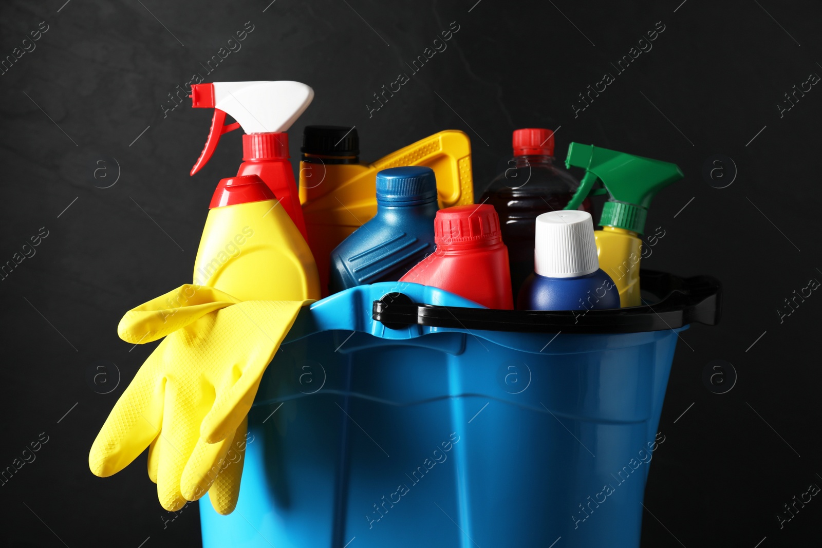 Photo of Light blue bucket with car cleaning products on black background