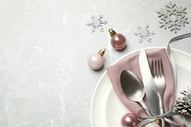 Beautiful Christmas table setting and festive decor on light grey marble background, flat lay. Space for text