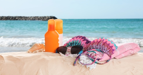 Image of Different beach accessories on sand near sea. Banner design 