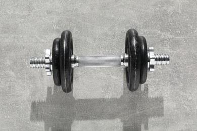 Photo of One barbell on grey textured background, top view