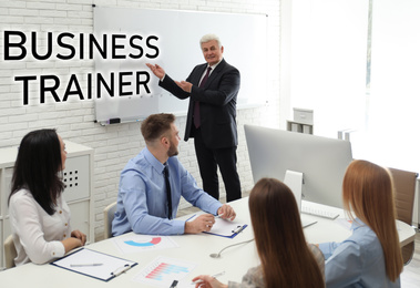 Image of Senior business trainer working with people in office