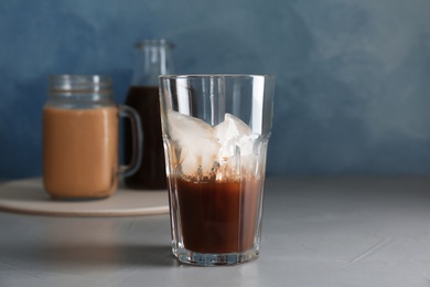 Glass with cold brew coffee on table