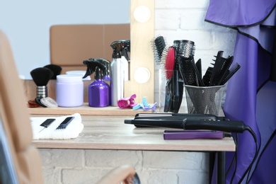 Photo of Hairdresser tools on table in salon