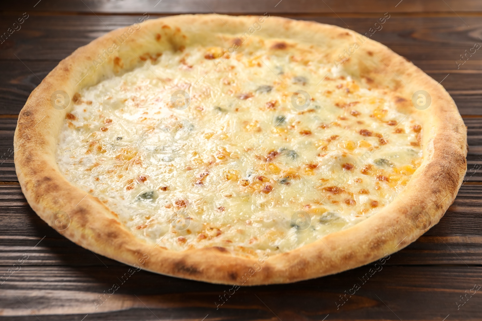 Photo of Delicious cheese pizza on wooden table, closeup