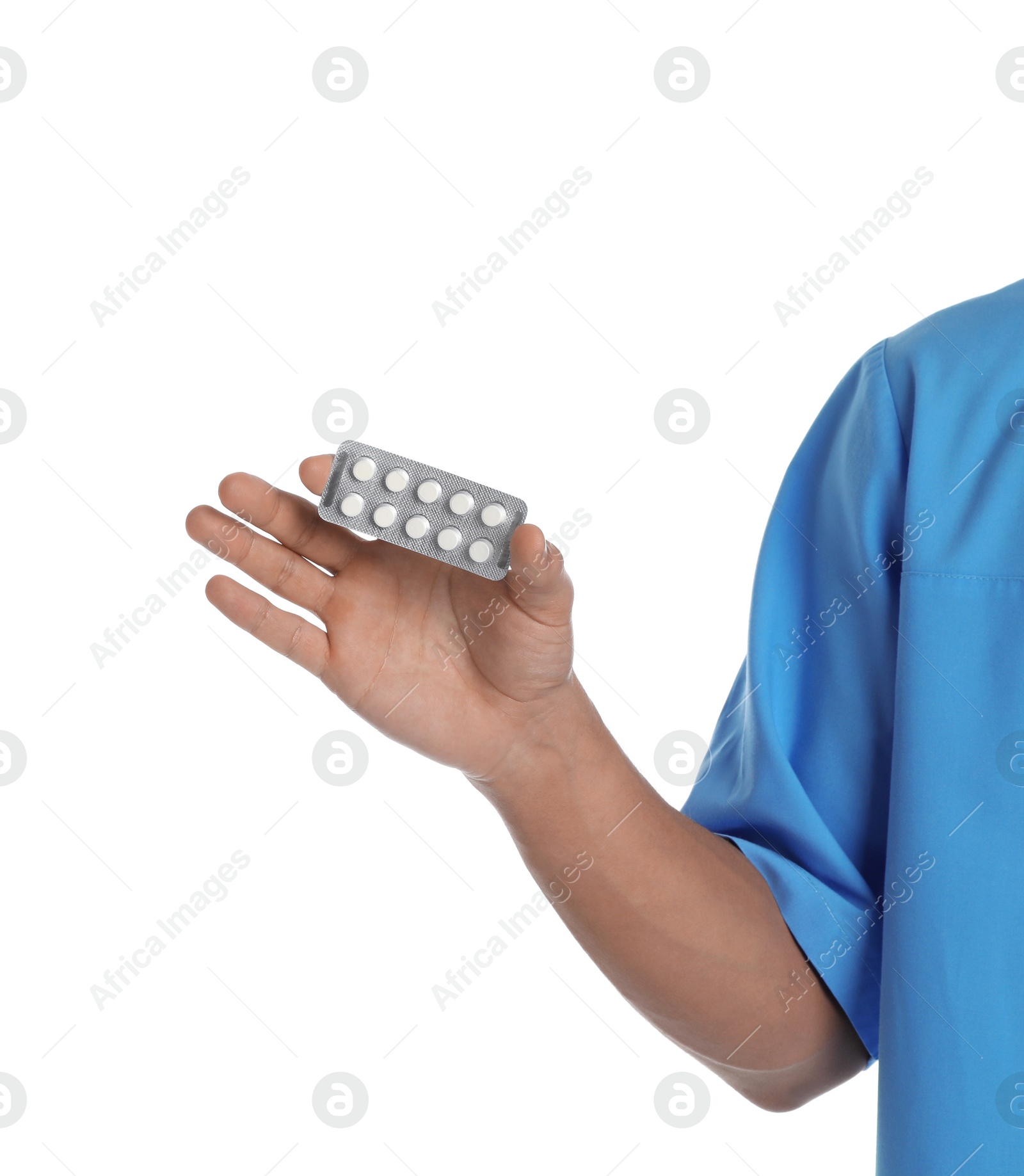 Photo of Male doctor holding pills on white background, closeup. Medical object