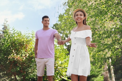 Photo of Lovely couple walking together in park on sunny day