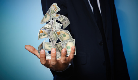 Image of Businessman cash money on dark background, closeup. Currency exchange