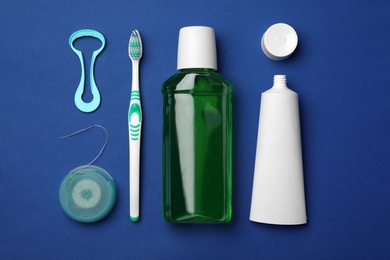 Flat lay composition with tongue cleaner and teeth care products on color background