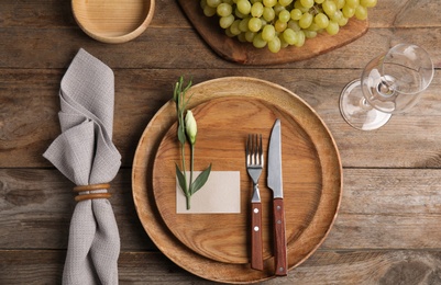 Elegant festive table setting on wooden background, flat lay