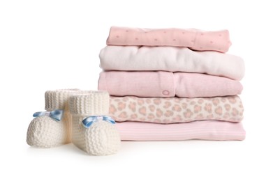 Photo of Stack of baby girl's clothes and booties on white background