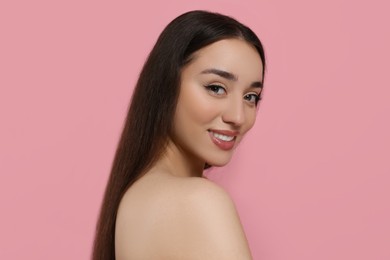 Photo of Portrait of beautiful young woman with elegant makeup on pink background