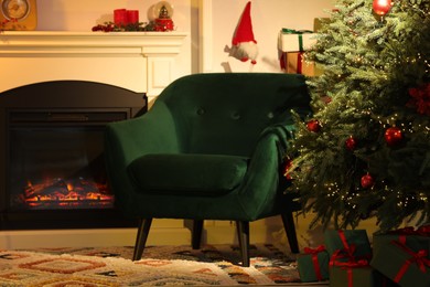 Photo of Living room interior with fireplace, armchair and Christmas decor
