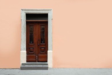 Photo of View of building with vintage wooden door, space for text. Exterior design