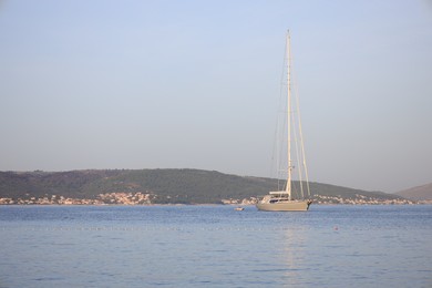 Photo of Beautiful view of tranquil sea and yacht on summer day